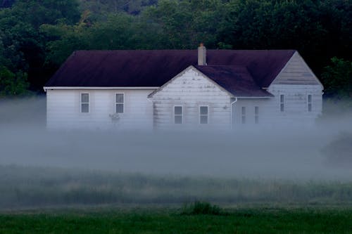 Exterior of a Haunted House Covered with Fog