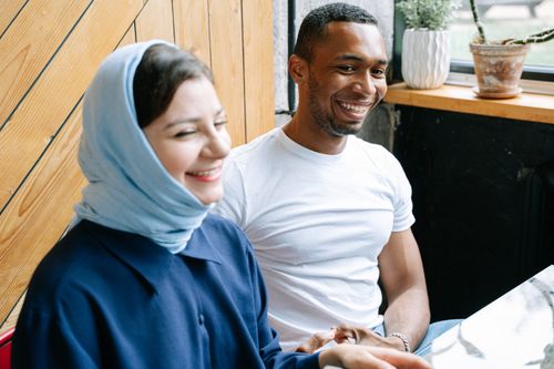Free Smiling friends enjoying time together indoors, highlighting friendship and happiness. Stock Photo