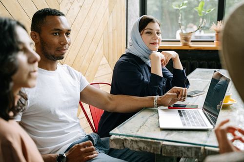 Free A diverse group of professionals engaged in collaborative work inside a modern workspace. Stock Photo