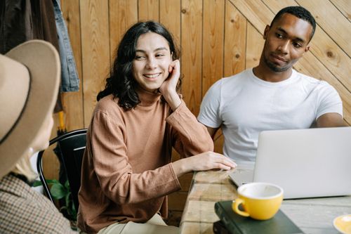 Free Three professionals collaborating in a cozy office setting, fostering teamwork. Stock Photo