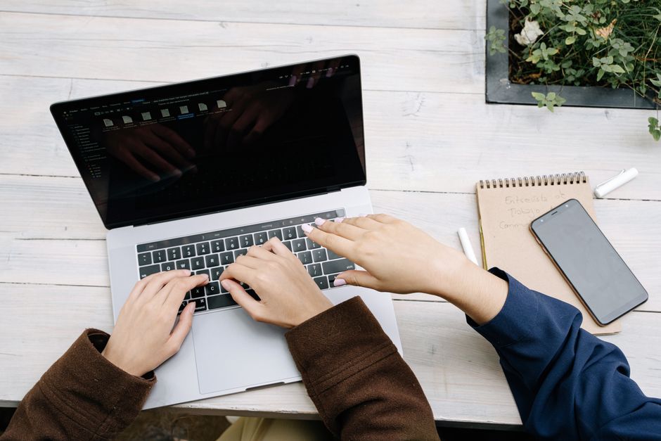 hands typing laptop content strategy