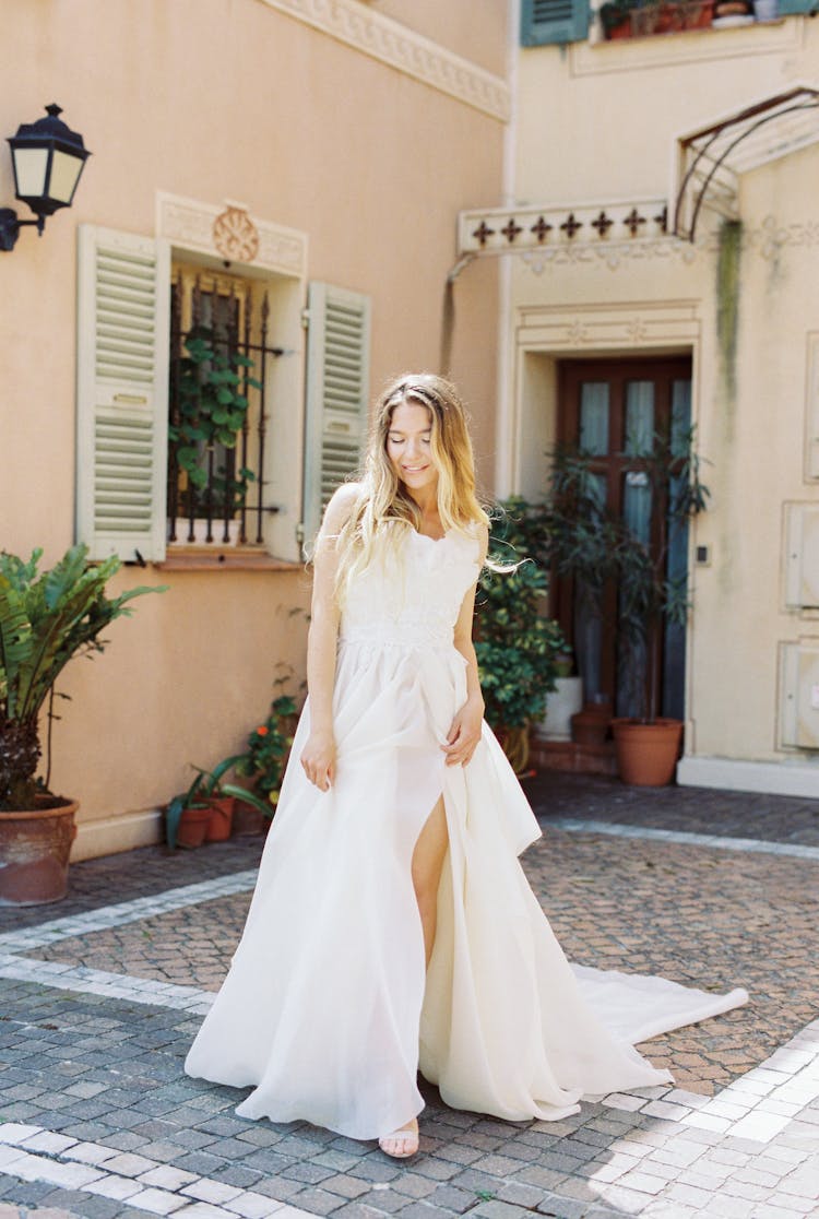 Woman In White Dress Standing On Paved Floor