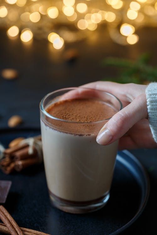 Person Holding a Cup of Chocolate Drink