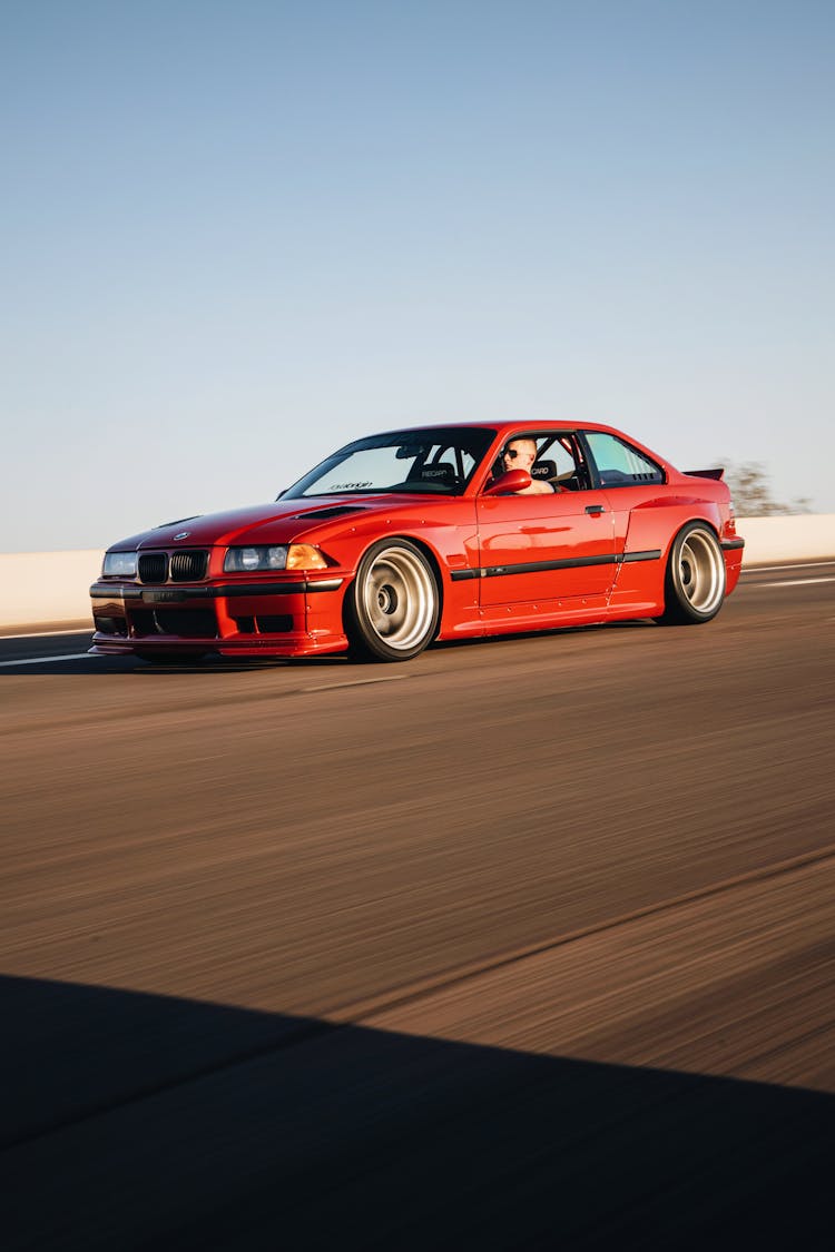 Man In A Red Car Driving At Speeds