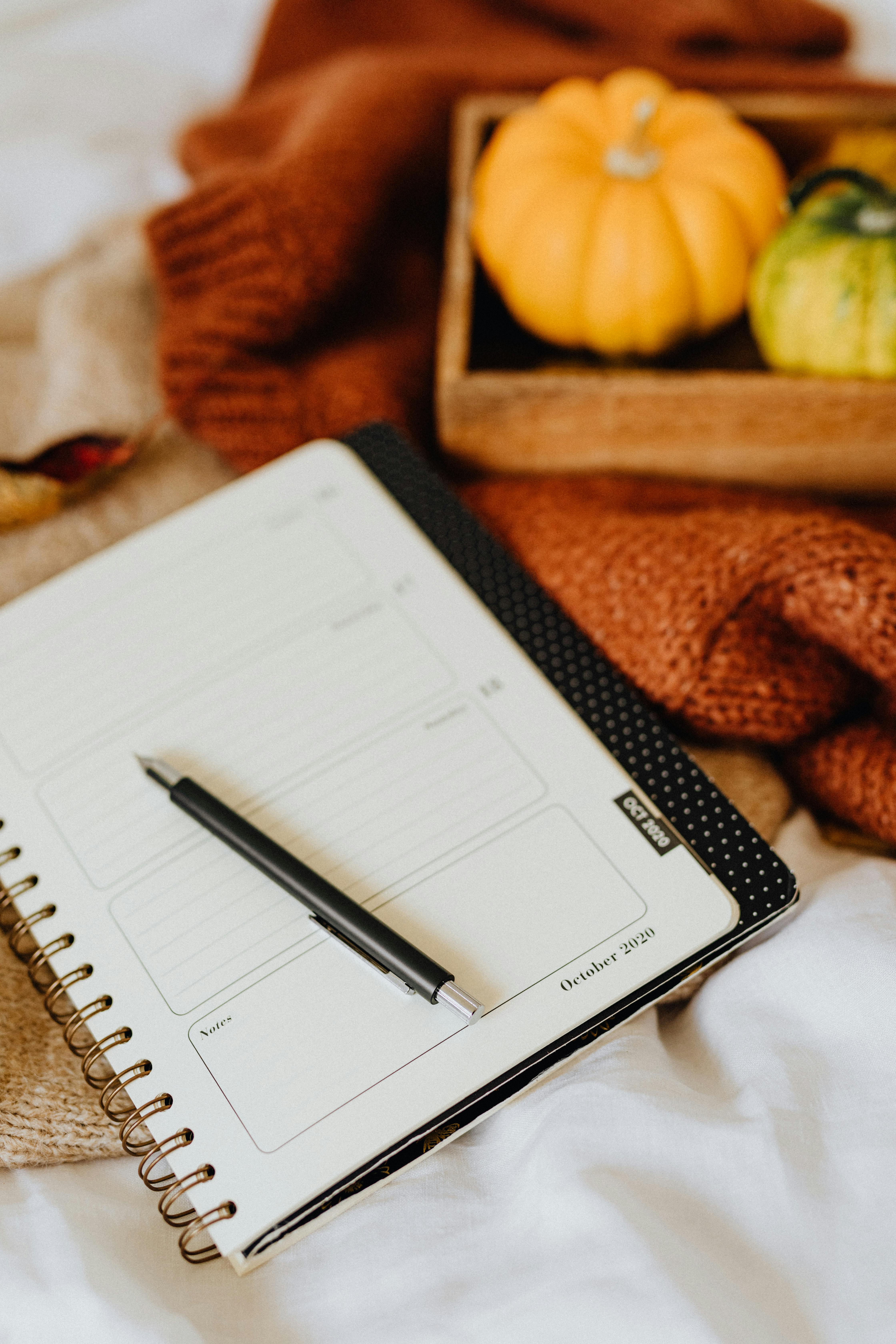 close up photo of a black pen on a journal