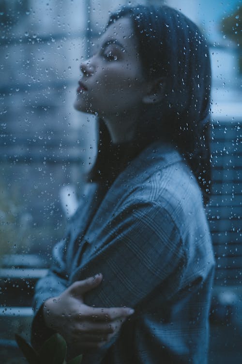 Free Unhappy thoughtful teen girl arms crossed in rainy day Stock Photo