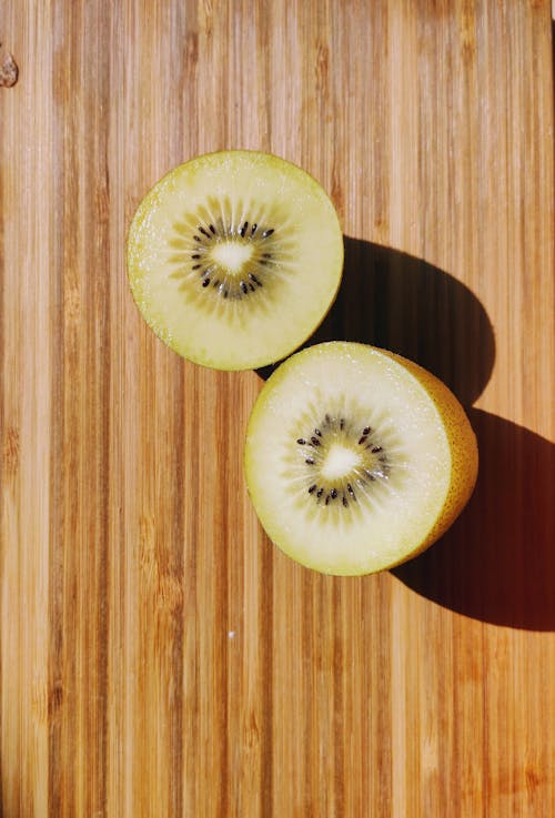Free Sliced Kiwi on Wooden Surface  Stock Photo