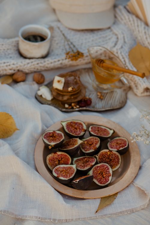 Free Artistic still life of figs and honey on a linen background, evoking a warm autumn feel. Stock Photo