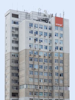 Exterior view of a modern high-rise building in Chișinău, Moldova with visible antennas.