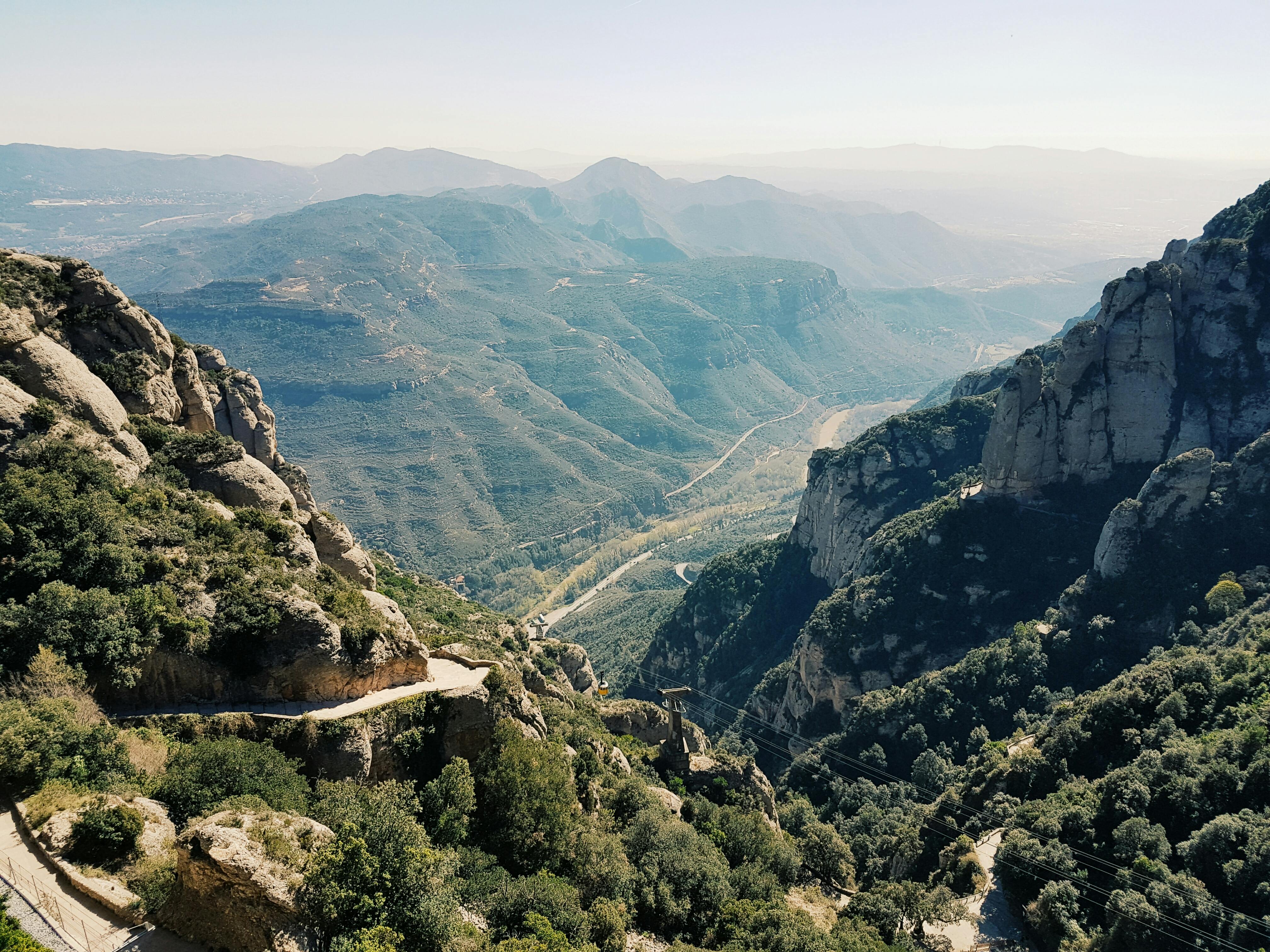 Free Breathtaking view of Montserrat mountains with winding paths and lush greenery. Stock Photo