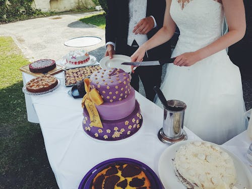 Couple Slicing Cake