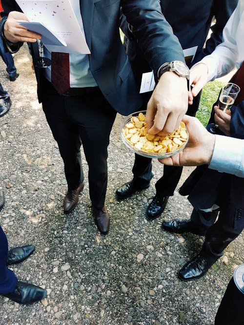 Person Getting Chips on Plate