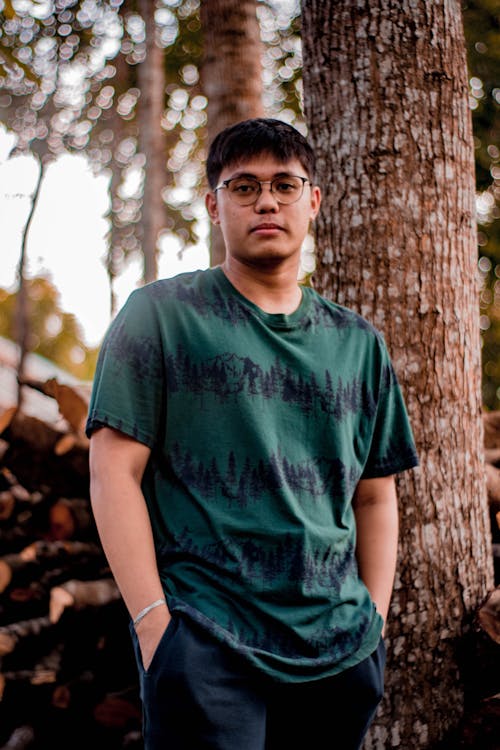 Man in Green Crew Neck T-shirt Standing Beside Tree
