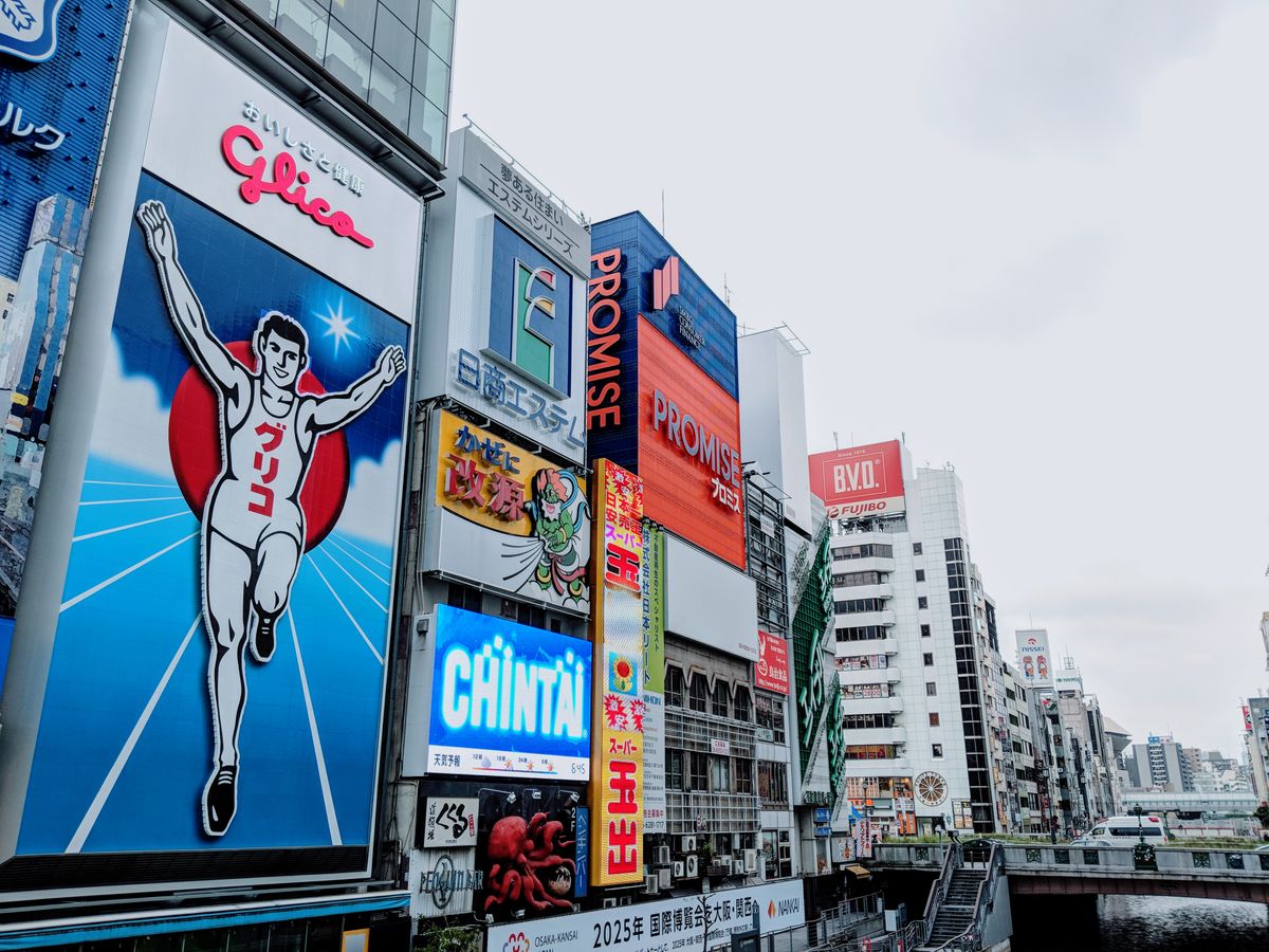 Vibrant neon advertisements in the Dotonbori district of Osaka including the famous Glico running man sign