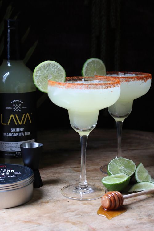 Free Two refreshing margaritas with lime slices and honey on a rustic table. Stock Photo