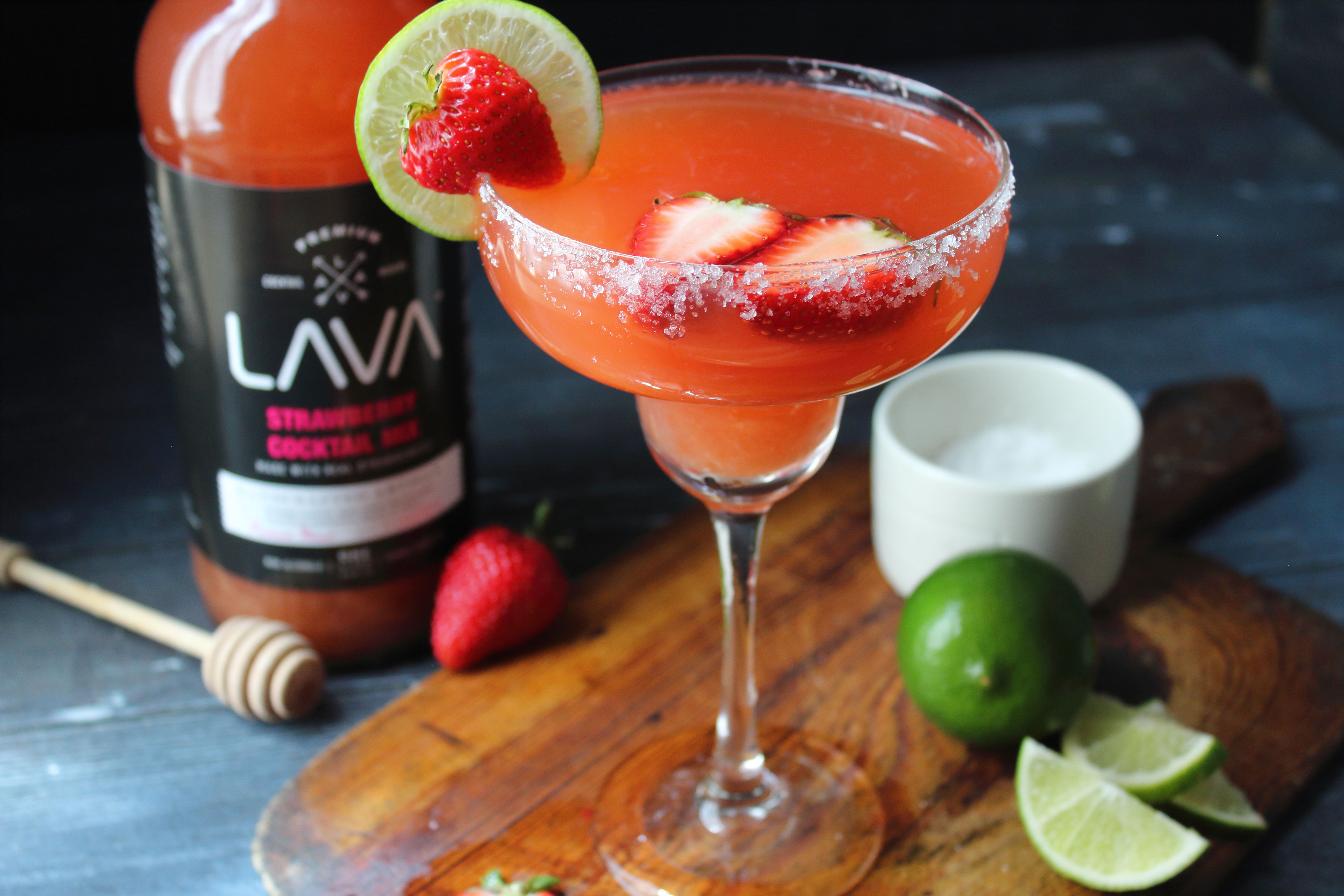 Frozen peach margarita in glass with salted rim