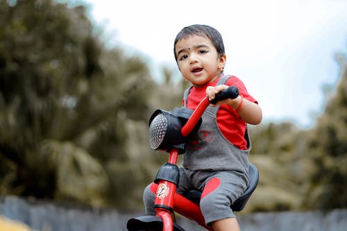 Cute Child riding a Toy Scooter 