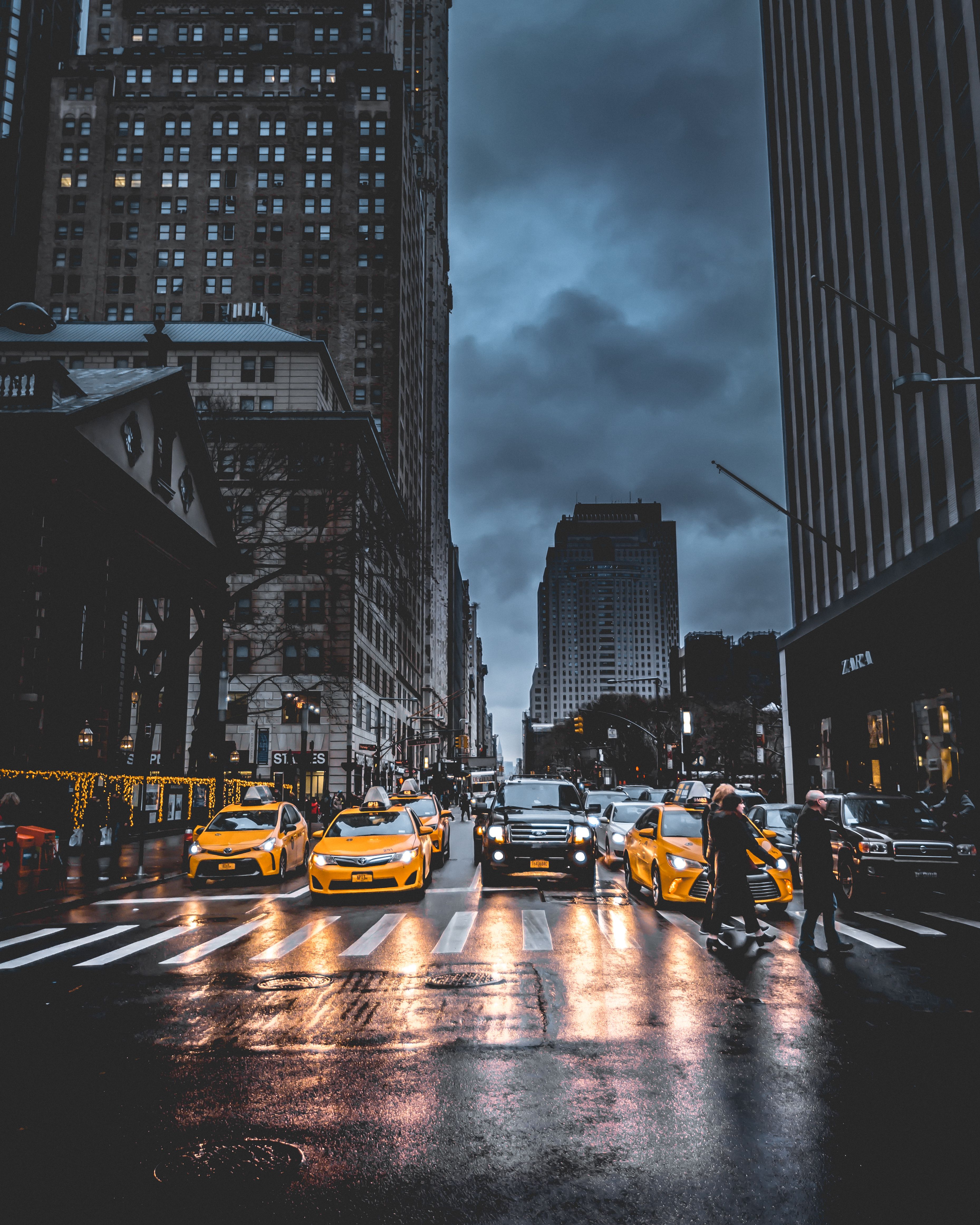 Cars on Road Between High Rise Buildings · Free Stock Photo