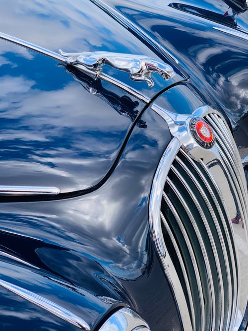 Free From above of luxury vintage car with shiny polished surface and chrome details parked on street on sunny day Stock Photo