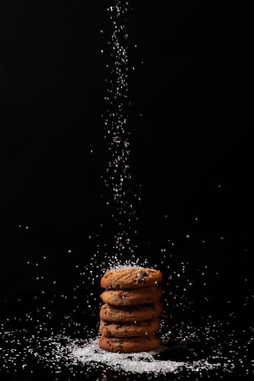Dropping of Sugar on Stacked Cookies 