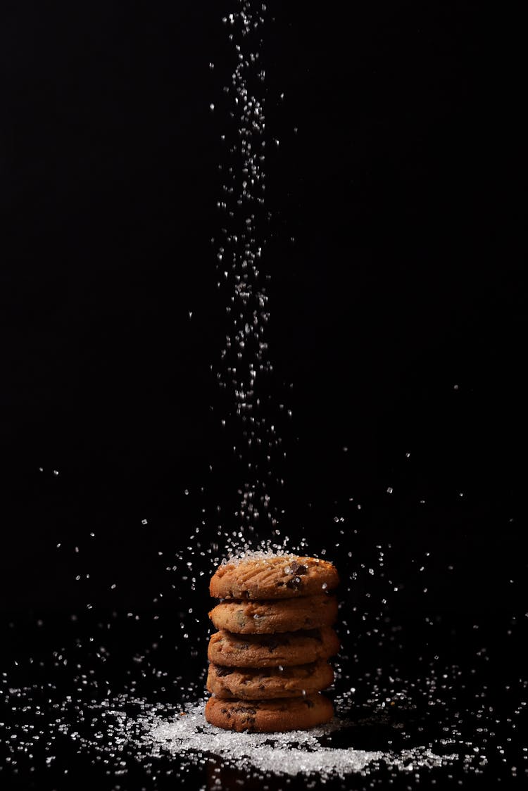 Dropping Of Sugar On Stacked Cookies 