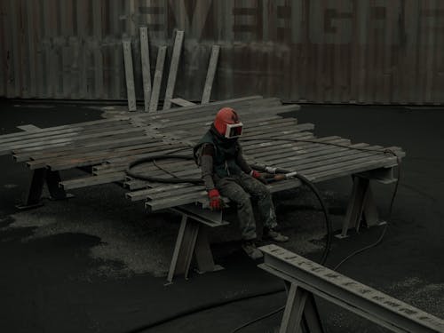 Tired Worker sitting on Steel Beams 