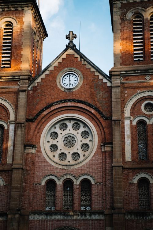Free Close-up of the clock tower on Notre-Dame Cathedral Basilica in Ho Chi Minh City, Vietnam. Stock Photo