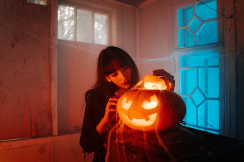 Free Woman With a Carved Pumpkin Stock Photo