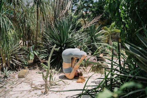 A Woman Practising Yoga in a Garden