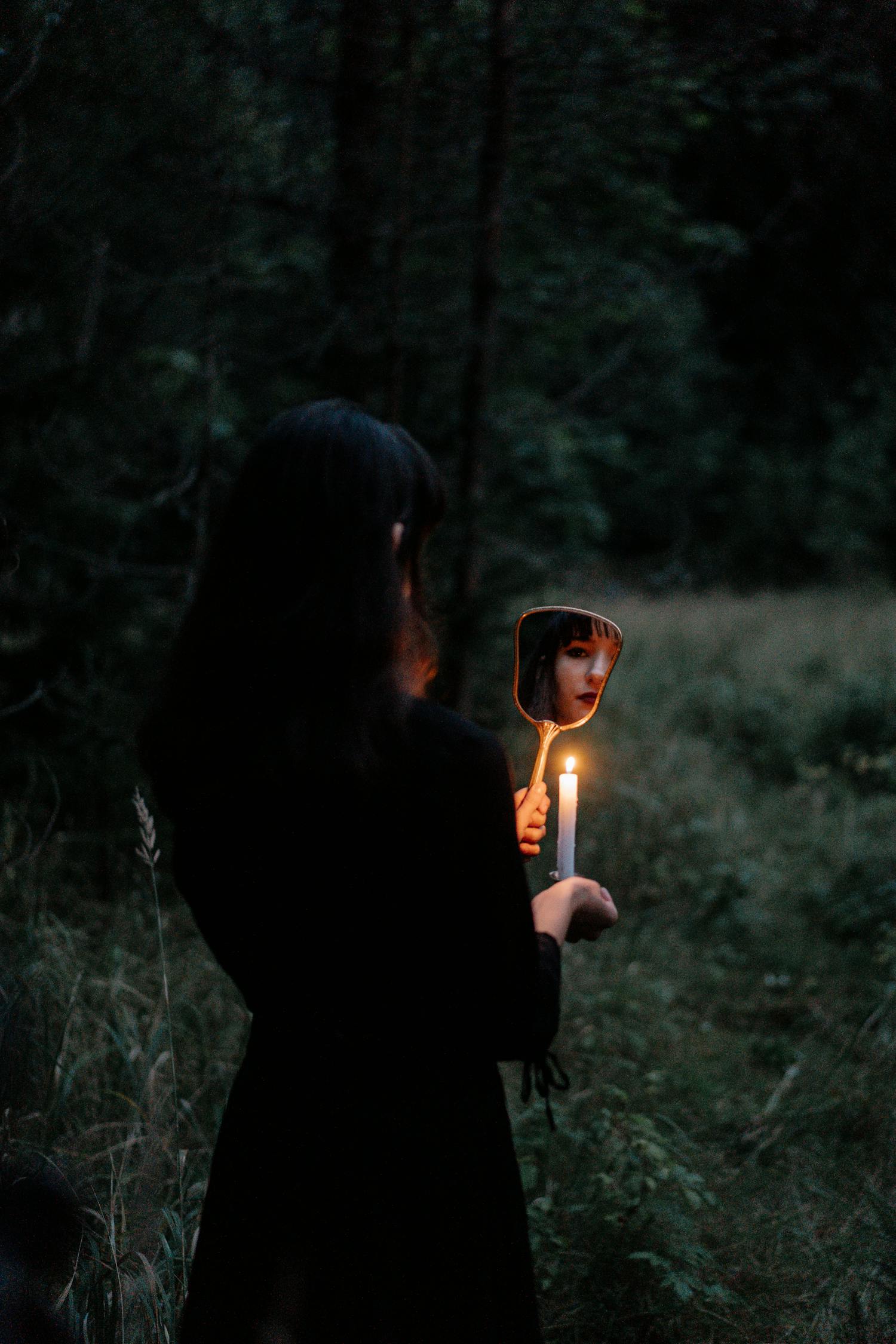 Woman in Black Long Sleeve Shirt Holding Lighted Candle · Free Stock Photo