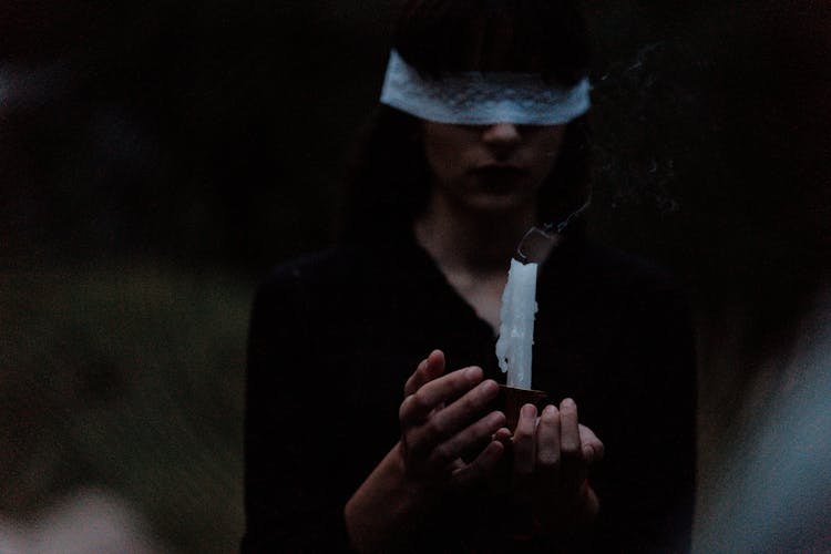 Blindfolded Woman With A Candle