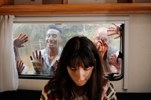 Free Zombies on Window behind a Girl  Stock Photo