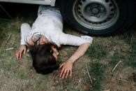 Dead Woman lying underneath a Car