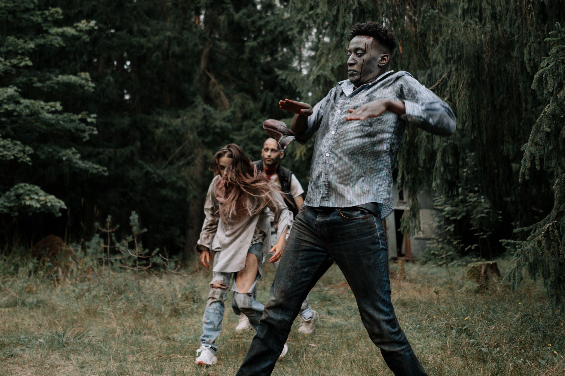 Terrifying zombies stumbling through a dark, creepy forest setting, perfect for horror themes.