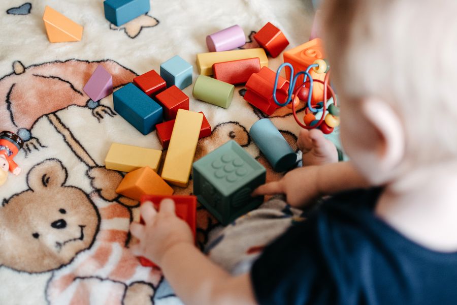 Fotografía de Pexels: Estimulación temprana Niño pequeño jugando con bloques de colores para estimular su aprendizaje