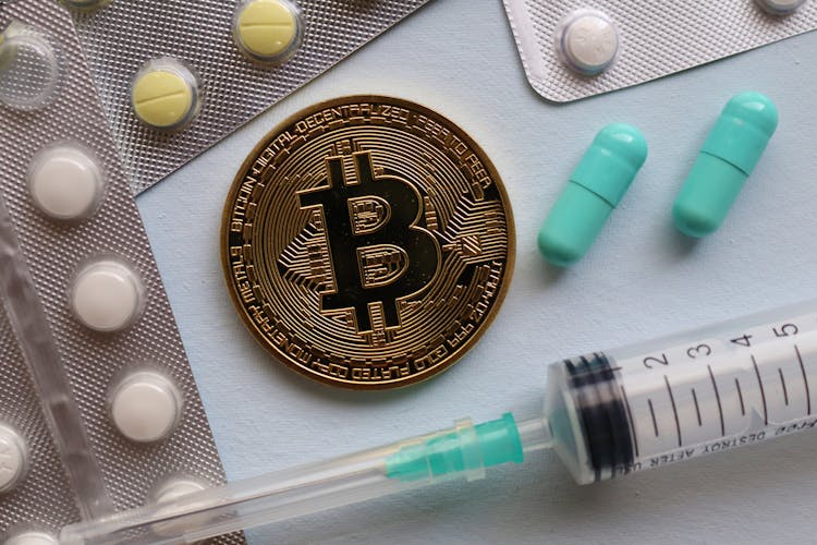 Bitcoin And Pills On Table