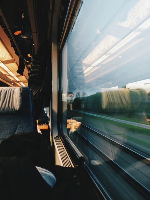 Free A serene view from inside a modern train, capturing the motion and landscape outside. Stock Photo