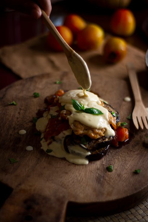 Burger With Green and White Cream on Brown Wooden Table