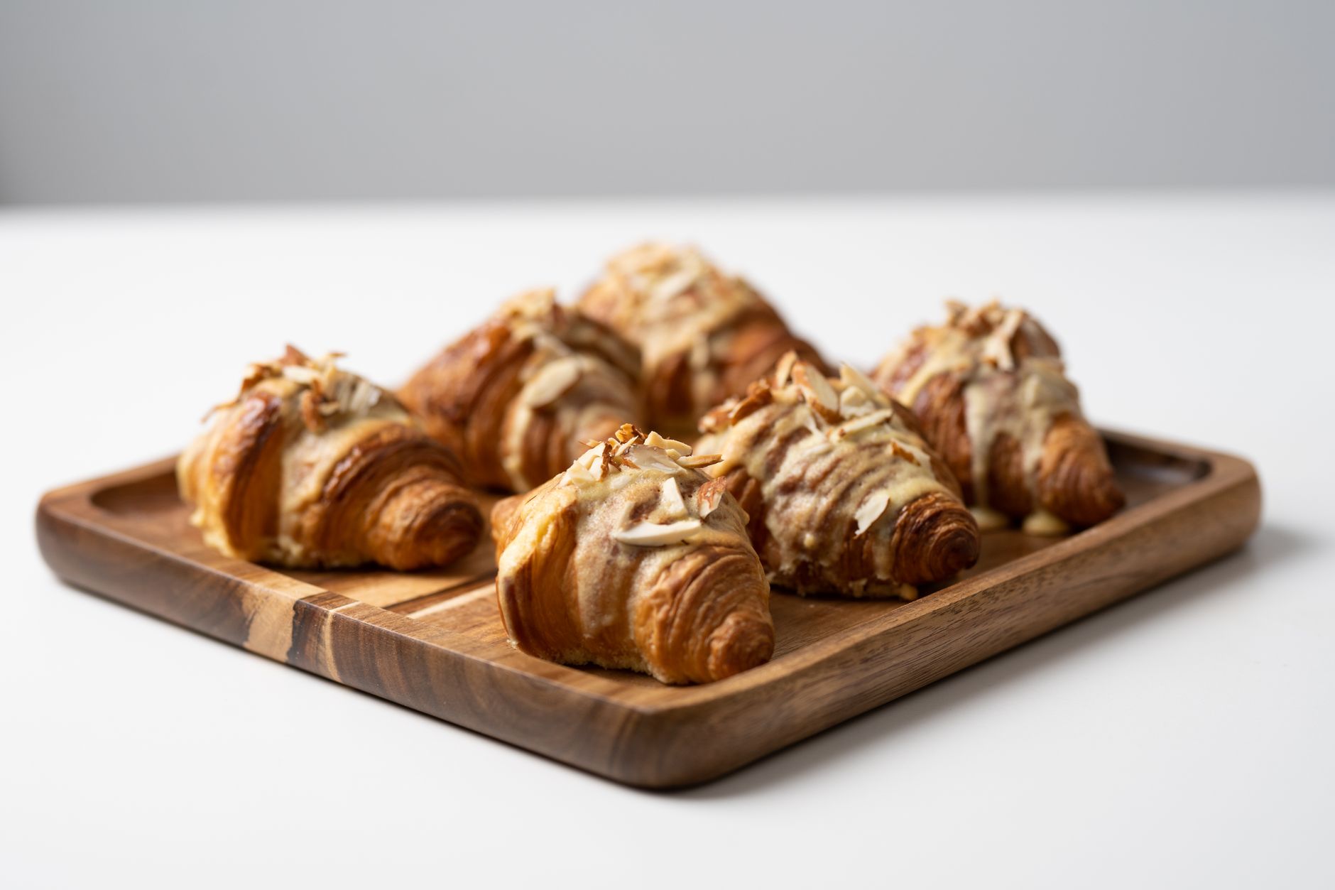 Freshly baked croissants on a cooling rack in a bakery