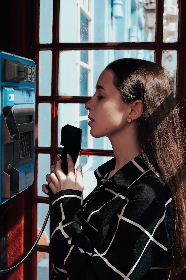 Charming Woman In Retro Phone Box