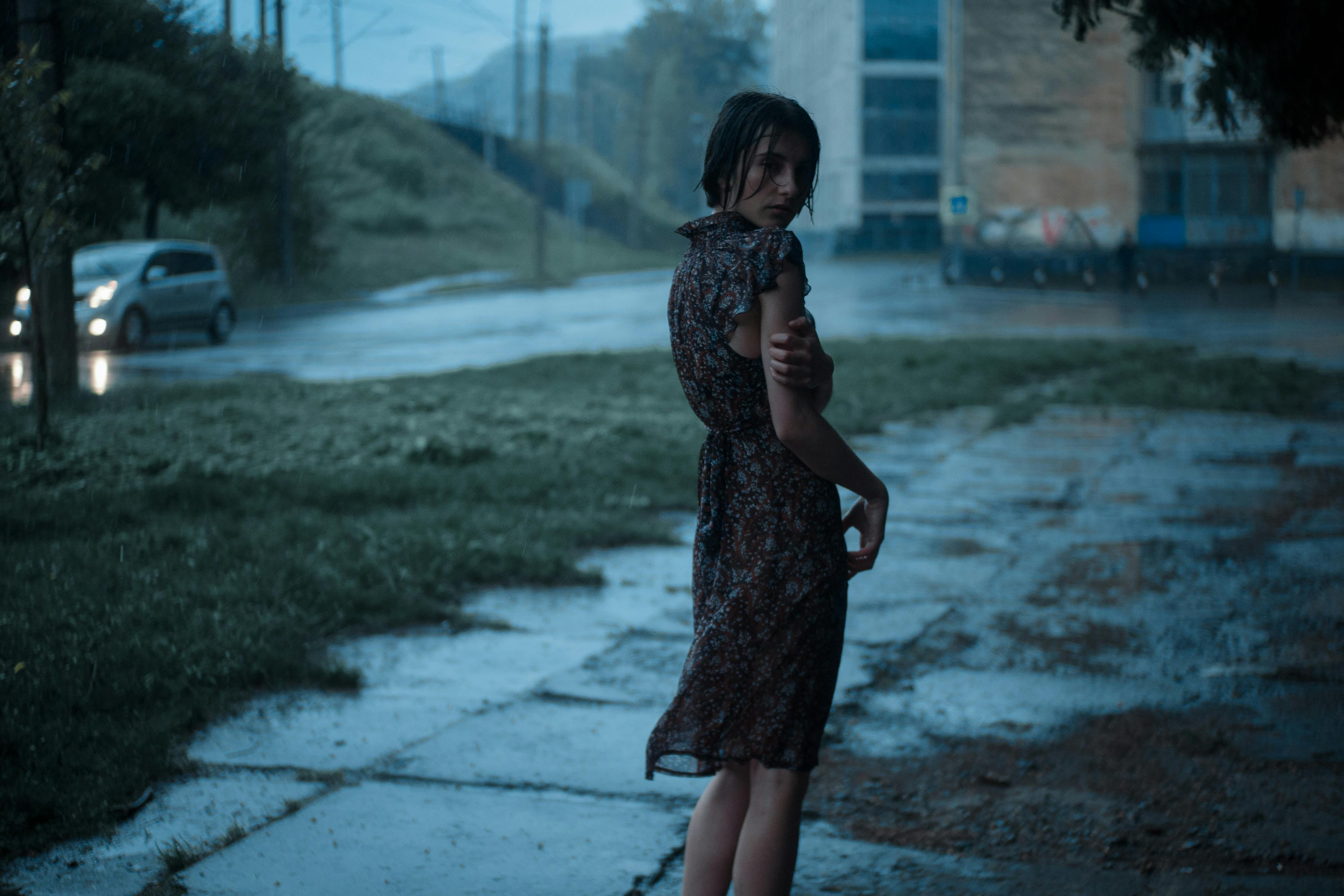 woman standing on street under rain