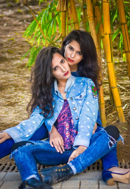Free Two fashionable women posing in a vibrant bamboo grove in Patna, India. Stock Photo