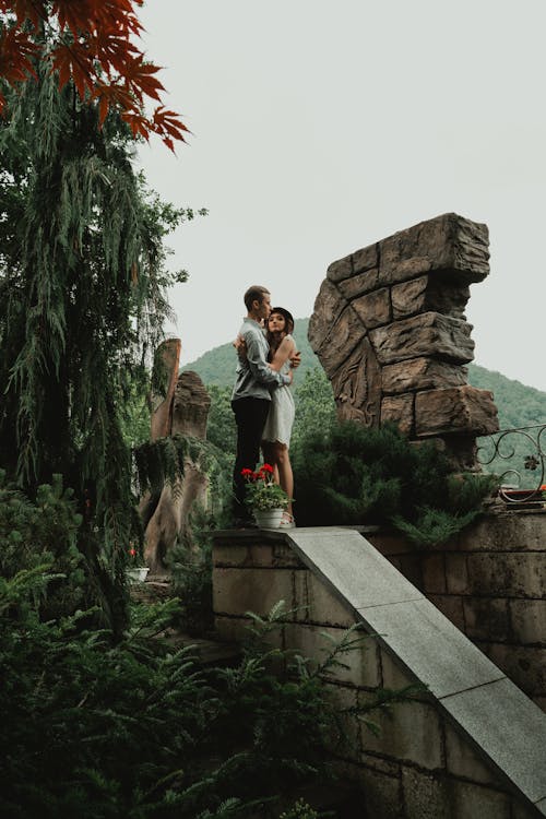 Couple Standing and Hugging on Concrete Wall