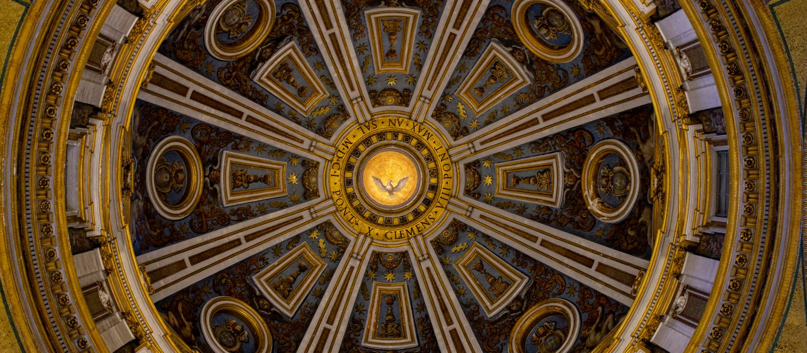 Detailed view of the ornate ceiling inside St. Peter's Basilica Dome, Vatican City.