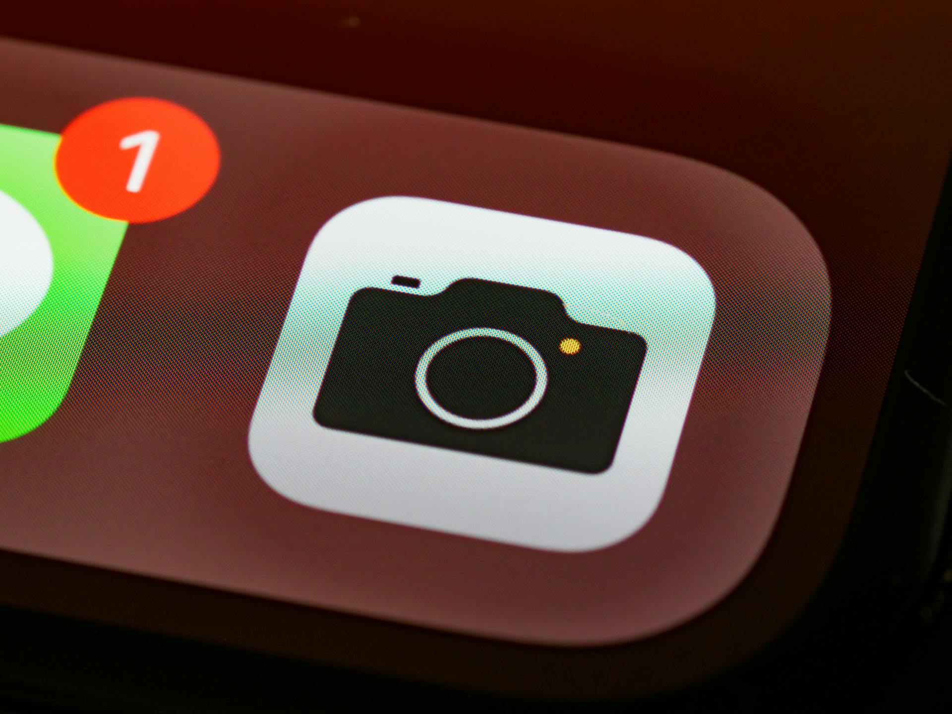 Detailed view of a smartphone camera app icon with notification badge.