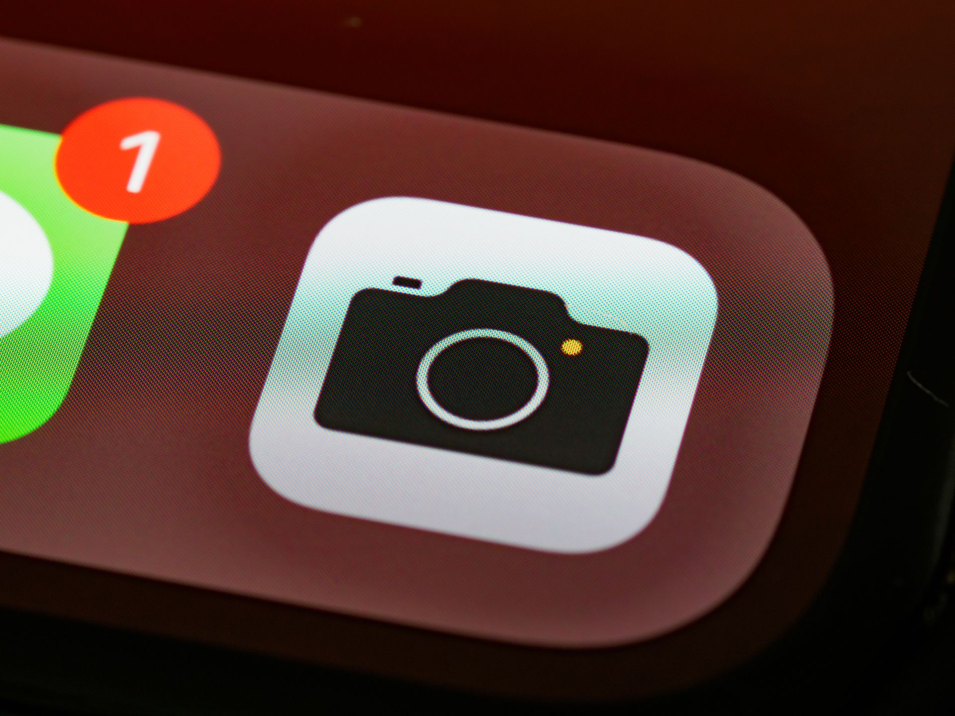 A smartphone camera lens photographed in close-up