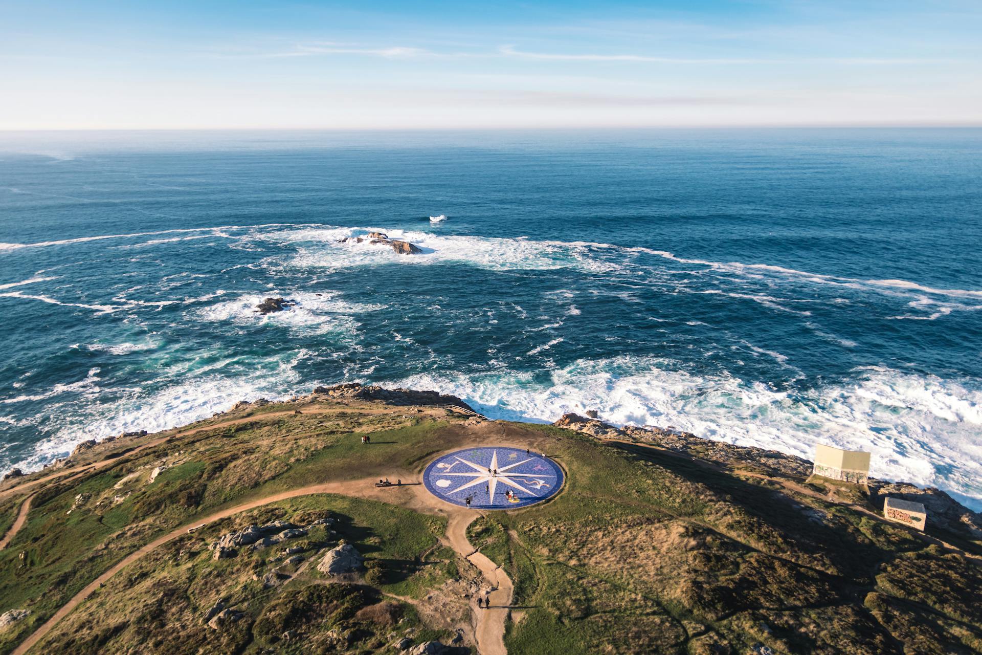 Stunning aerial photo of A Coruña's coast featuring the iconic Compass Rose and Atlantic waves.