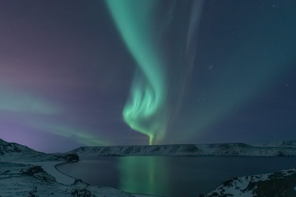 Northern Lights Above Lake and Snowy Landscape