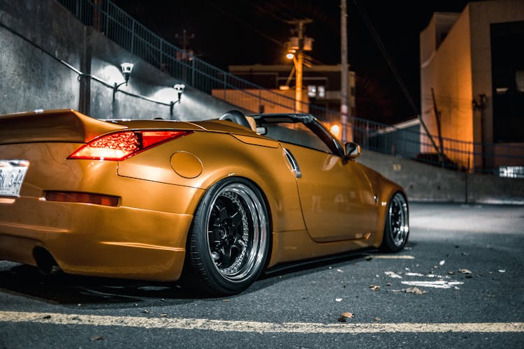 Modern Racing Car On Roadway In City At Night