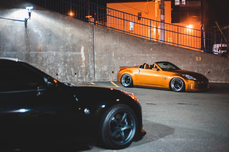 Modern Sports Cars On Road In Night City